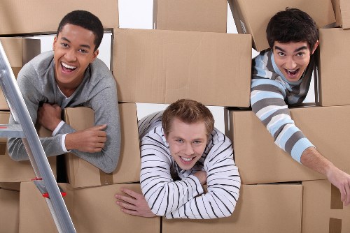 Removal staff carrying furniture carefully through a property