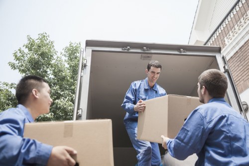 Removal crew carrying furniture from a flat with stairs in Tufnell Park