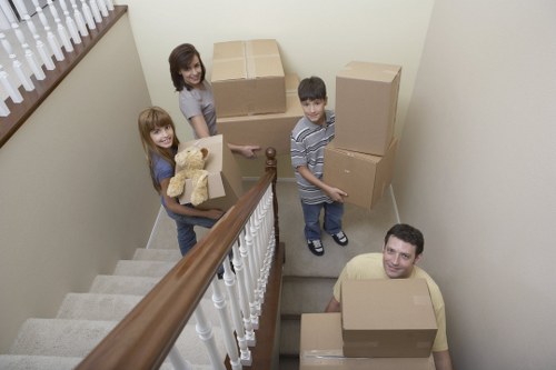 Local furniture collection team handling removals in a North London street